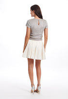 PLEATED MINI SKIRT WITH CRYSTAL BOWS