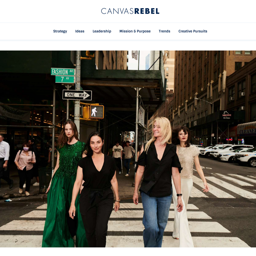 A magazine or editorial webpage screenshot featuring a city street scene with four women walking across a crosswalk. The headline at the top reads CANVAS REBEL, and the lower headline reads Meet Emily Shalant.